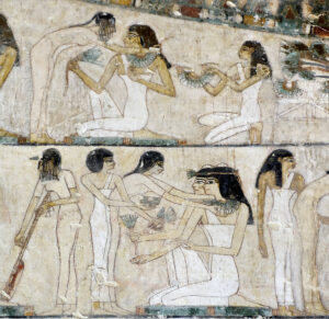 Rekhmire's funeral banquet. Servants offer lotus flowers and necklaces to female guests.