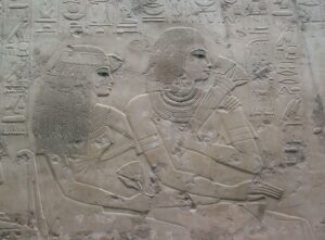 Ramose holding Lotus Flowers and his wife Meryt-Ptah wearing a Lotus Flower in her headband.
